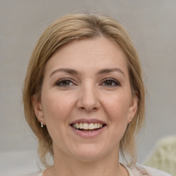 Joyful white adult female with medium  brown hair and brown eyes