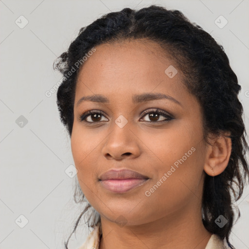 Joyful black young-adult female with long  black hair and brown eyes