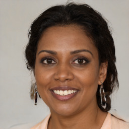 Joyful black young-adult female with medium  brown hair and brown eyes