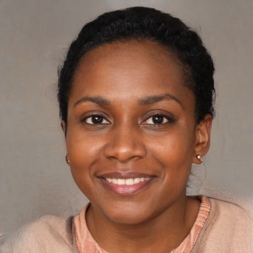 Joyful black young-adult female with short  black hair and brown eyes