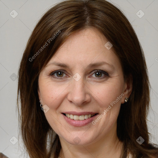 Joyful white adult female with medium  brown hair and brown eyes