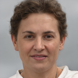 Joyful white adult female with short  brown hair and brown eyes