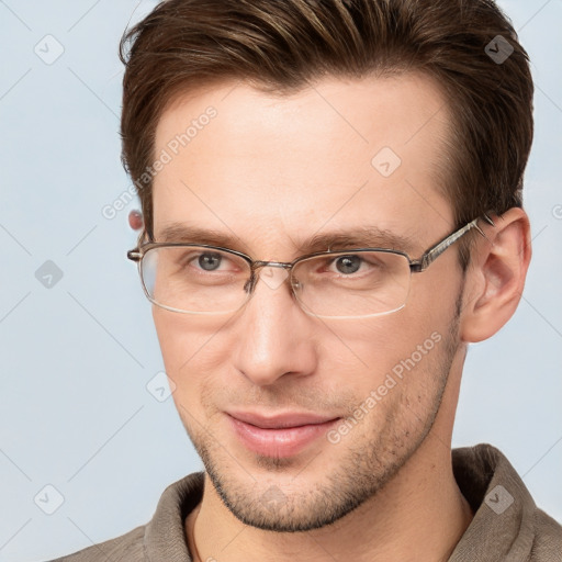 Joyful white adult male with short  brown hair and grey eyes