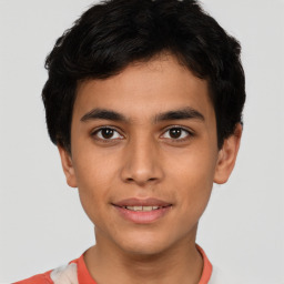 Joyful latino young-adult male with short  brown hair and brown eyes