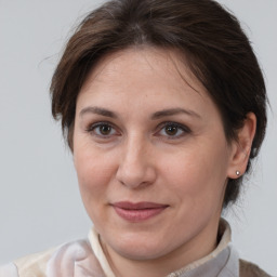 Joyful white adult female with medium  brown hair and brown eyes