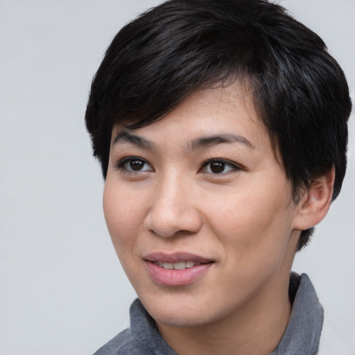 Joyful asian young-adult female with short  black hair and brown eyes