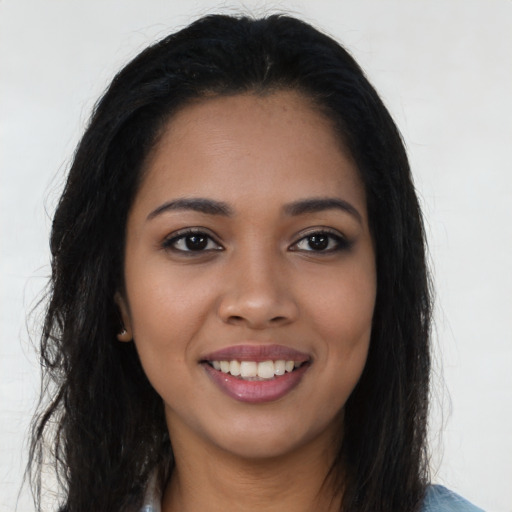 Joyful latino young-adult female with long  black hair and brown eyes