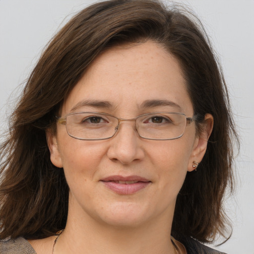 Joyful white adult female with medium  brown hair and brown eyes