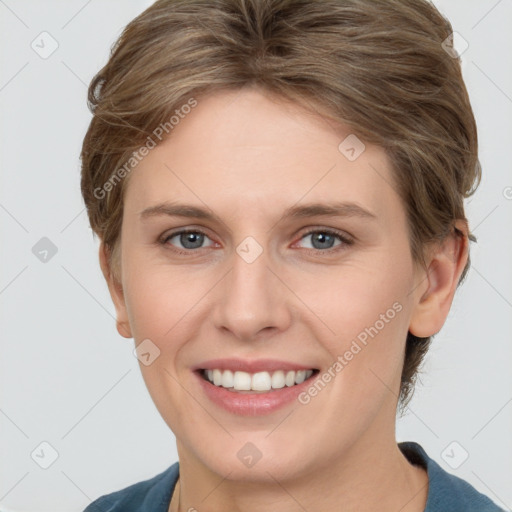 Joyful white young-adult female with short  brown hair and grey eyes