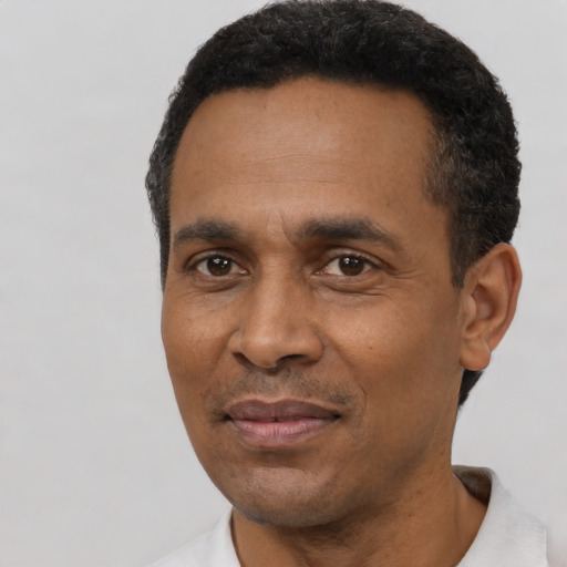 Joyful latino adult male with short  black hair and brown eyes