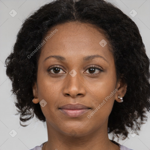 Joyful black young-adult female with long  brown hair and brown eyes