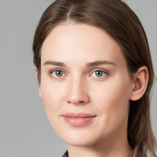 Joyful white young-adult female with long  brown hair and grey eyes