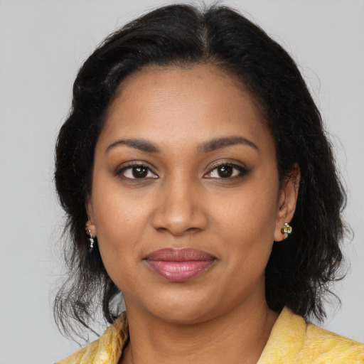 Joyful black young-adult female with medium  brown hair and brown eyes