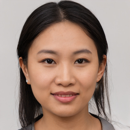 Joyful asian young-adult female with medium  brown hair and brown eyes