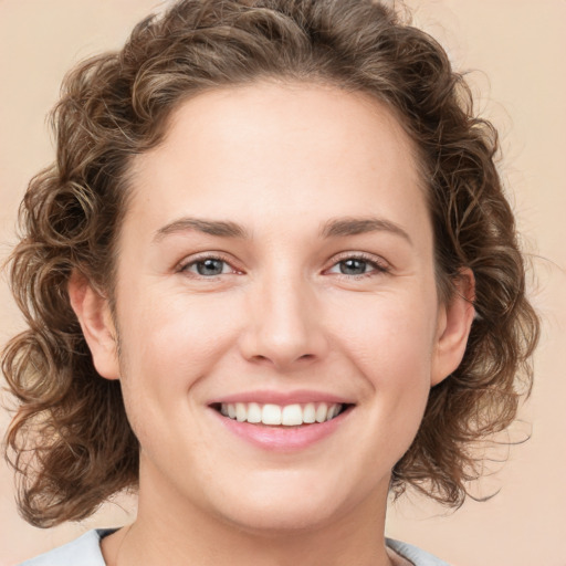 Joyful white young-adult female with medium  brown hair and green eyes