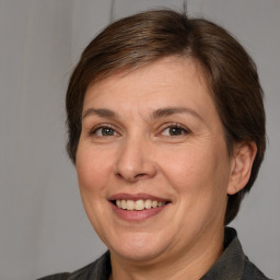 Joyful white adult female with medium  brown hair and brown eyes