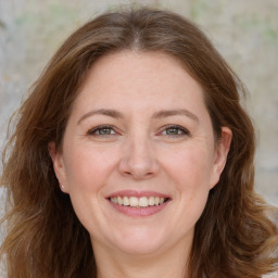 Joyful white adult female with long  brown hair and brown eyes