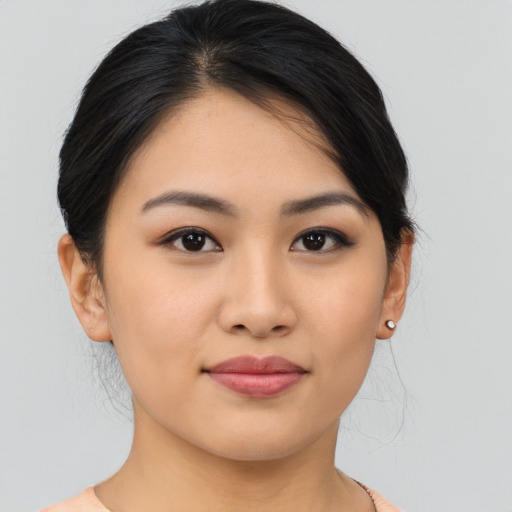 Joyful asian young-adult female with medium  black hair and brown eyes