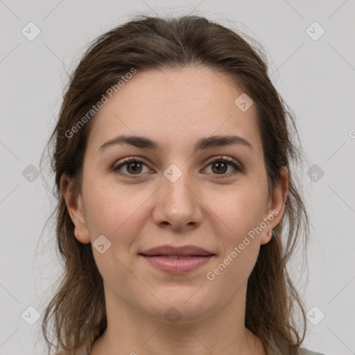 Joyful white young-adult female with long  brown hair and brown eyes