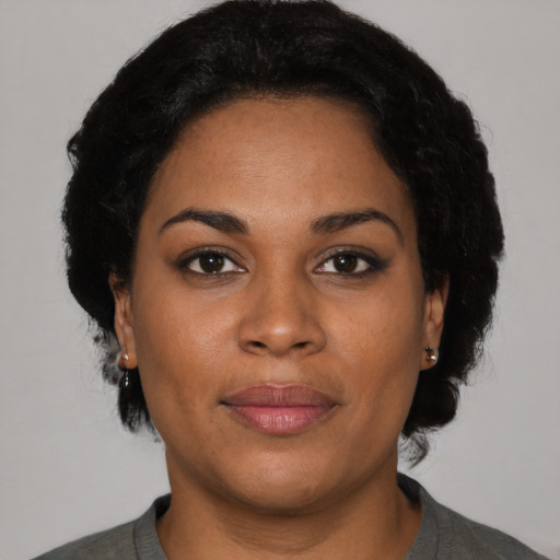 Joyful black adult female with short  black hair and brown eyes