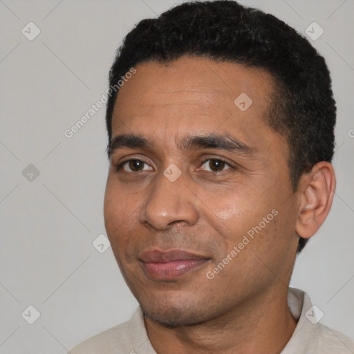 Joyful black young-adult male with short  black hair and brown eyes