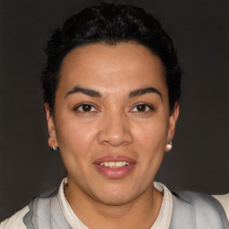 Joyful latino young-adult female with short  black hair and brown eyes