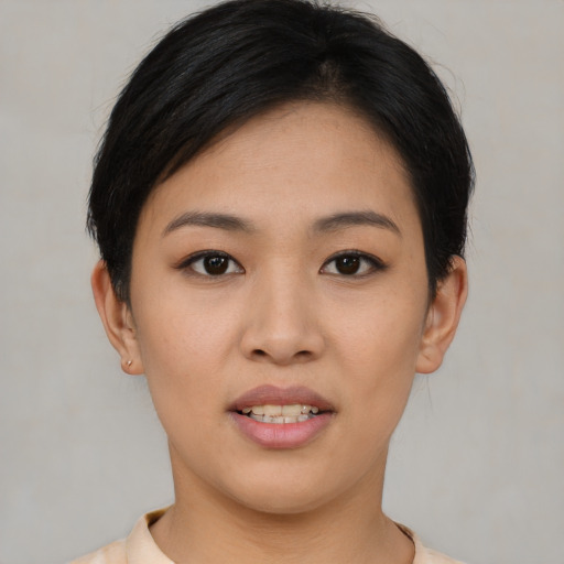 Joyful asian young-adult female with short  black hair and brown eyes