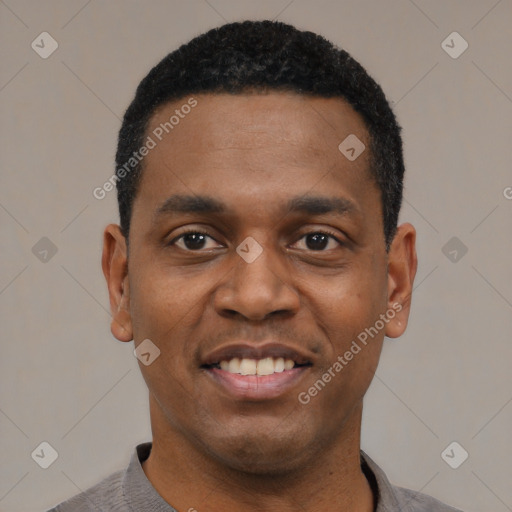 Joyful black young-adult male with short  black hair and brown eyes