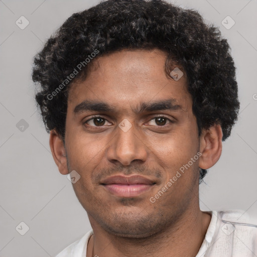 Joyful black young-adult male with short  brown hair and brown eyes