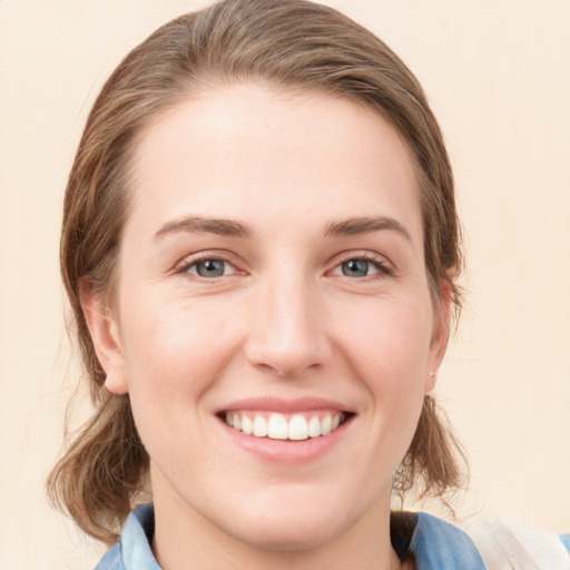 Joyful white young-adult female with medium  brown hair and blue eyes