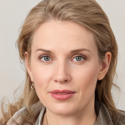 Joyful white young-adult female with medium  brown hair and blue eyes