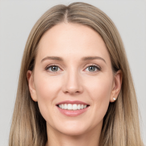 Joyful white young-adult female with long  brown hair and grey eyes