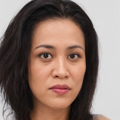 Joyful asian young-adult female with long  brown hair and brown eyes