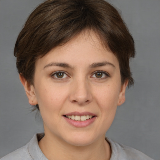 Joyful white young-adult female with short  brown hair and brown eyes