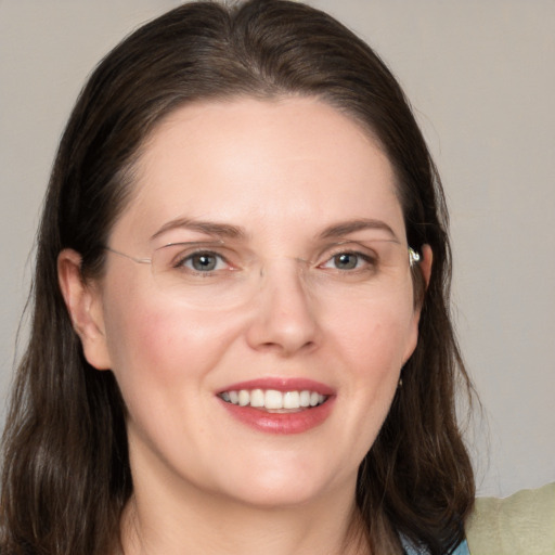 Joyful white young-adult female with medium  brown hair and grey eyes