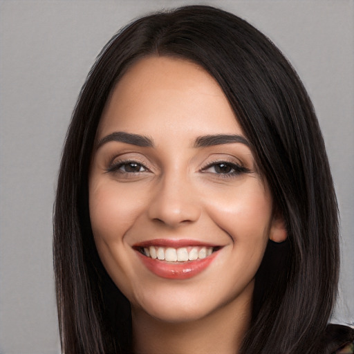 Joyful white young-adult female with long  black hair and brown eyes