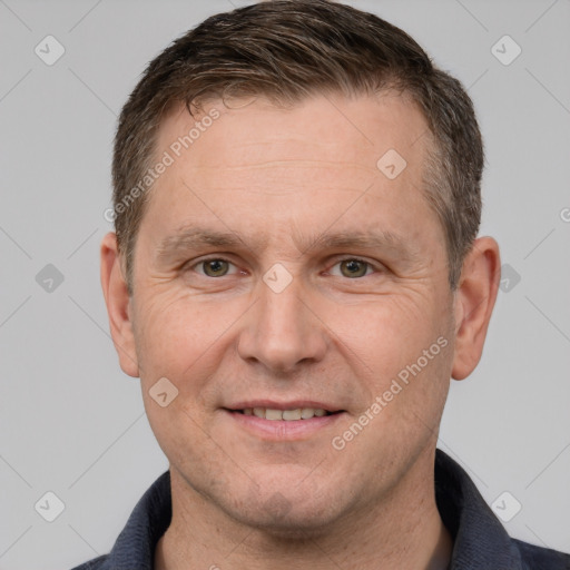 Joyful white adult male with short  brown hair and grey eyes