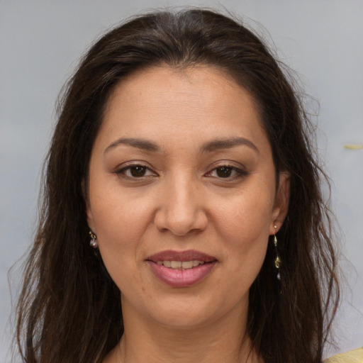 Joyful white adult female with long  brown hair and brown eyes
