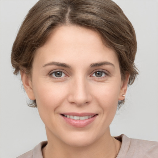 Joyful white young-adult female with short  brown hair and grey eyes