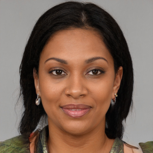 Joyful black young-adult female with medium  brown hair and brown eyes
