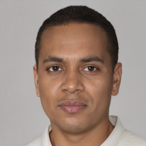 Joyful black young-adult male with short  brown hair and brown eyes
