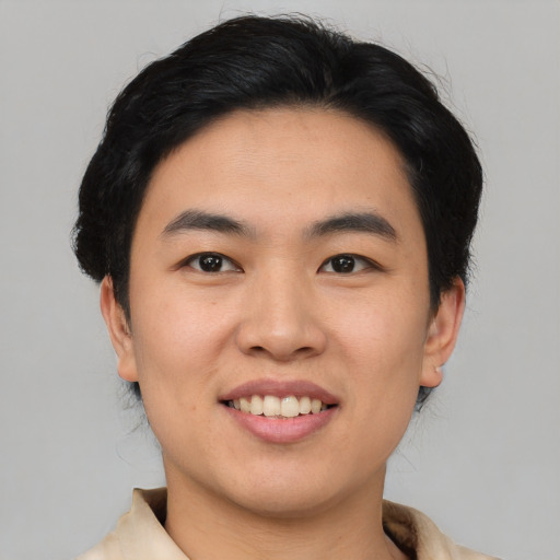 Joyful asian young-adult male with short  black hair and brown eyes