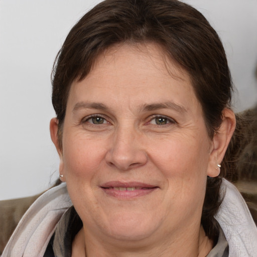 Joyful white adult female with medium  brown hair and brown eyes