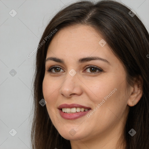 Joyful white young-adult female with long  brown hair and brown eyes