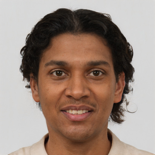 Joyful black adult male with short  brown hair and brown eyes