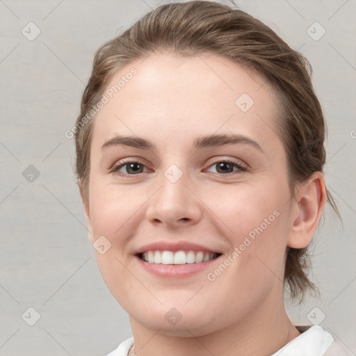 Joyful white young-adult female with medium  brown hair and grey eyes