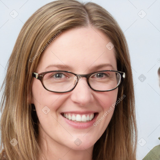 Joyful white young-adult female with long  brown hair and blue eyes