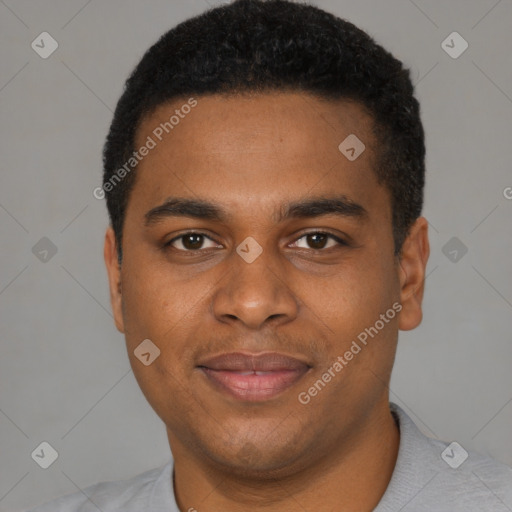 Joyful black young-adult male with short  black hair and brown eyes