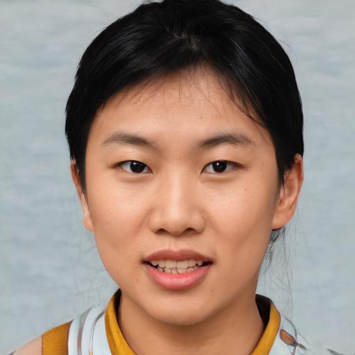 Joyful asian young-adult female with short  brown hair and brown eyes