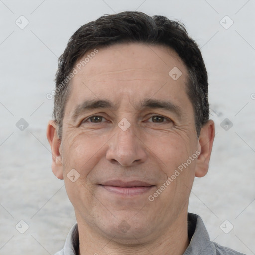 Joyful white adult male with short  brown hair and brown eyes